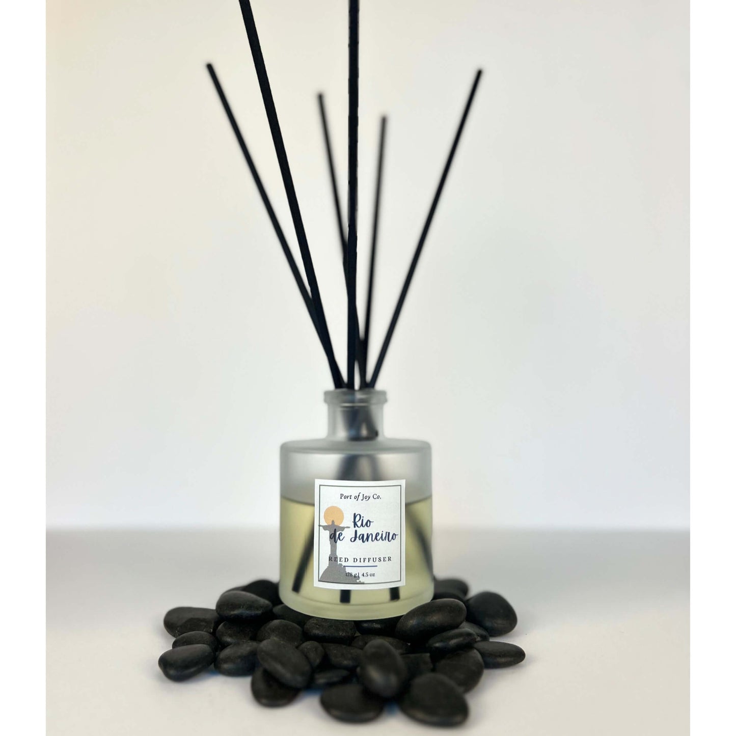 Reed diffuser with black sticks on a white background