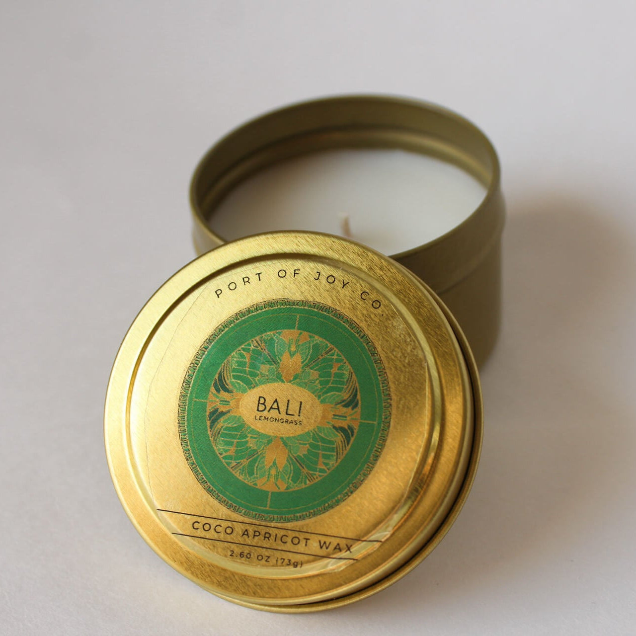 handmade Candle in a gold tin with 'Bali' label on a white background.