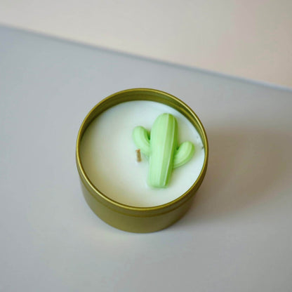 Candle in a tin with a cactus-shaped wick on a neutral background