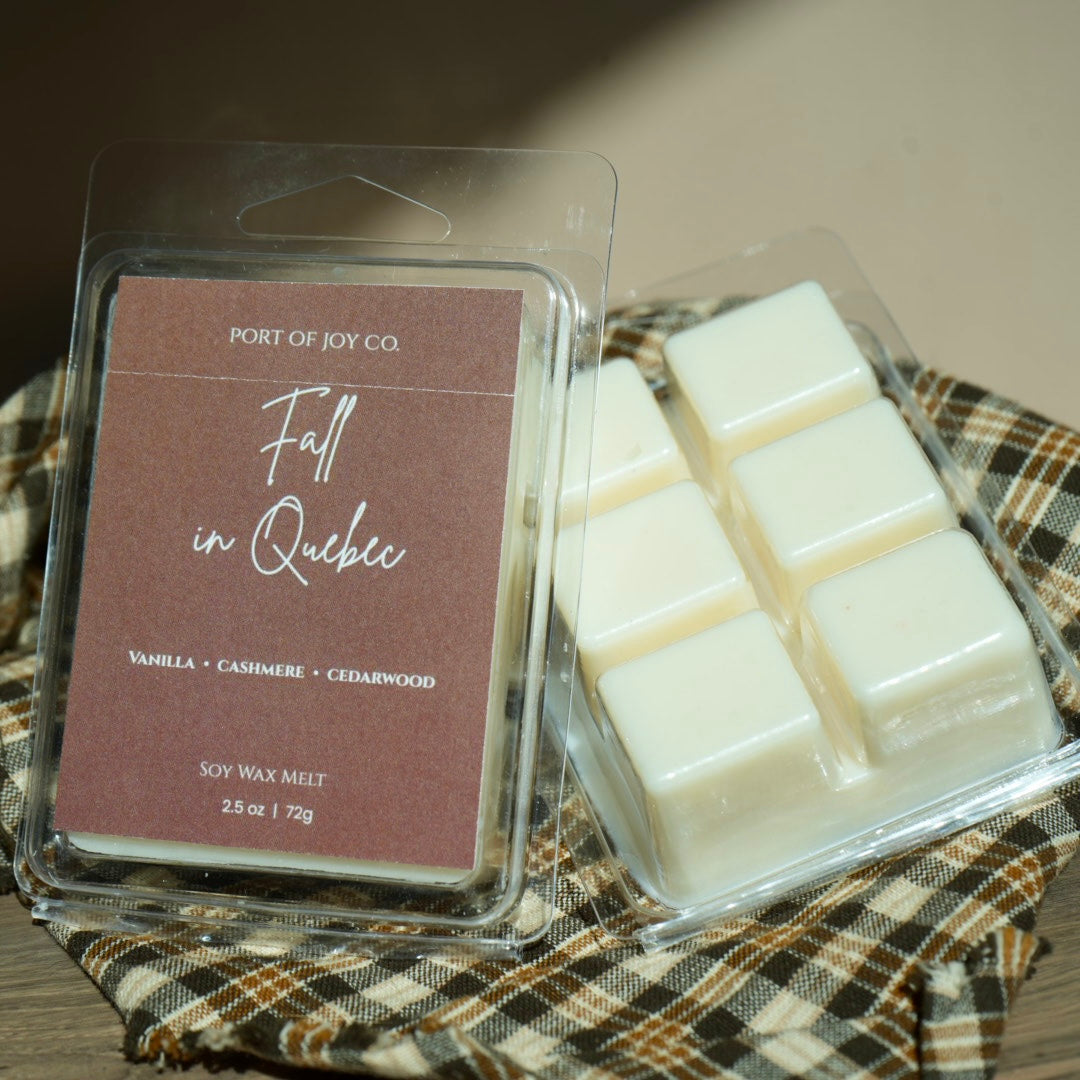 Port of Joy Co. 'Fall in Quebec' soy wax melt in a clear clamshell package, showing the browned label and six white wax cubes 