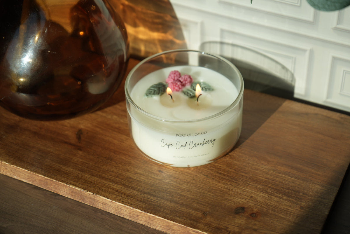 Cranberry candle scented with apple, orange peel, clove, and woods