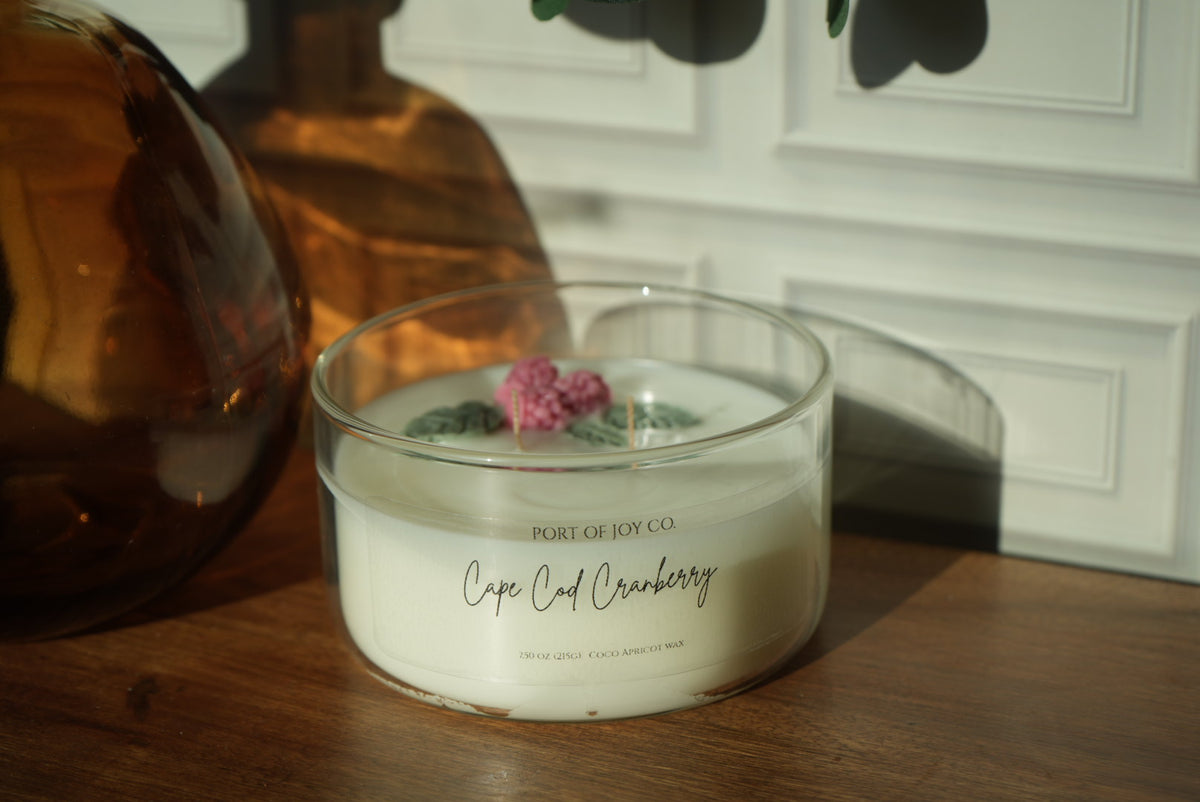 Cranberry candle featuring orange, apple, clove, and soft wood notes