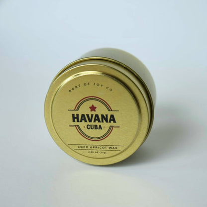gold tin labeled 'Havana Cuba'. travel size candle for men