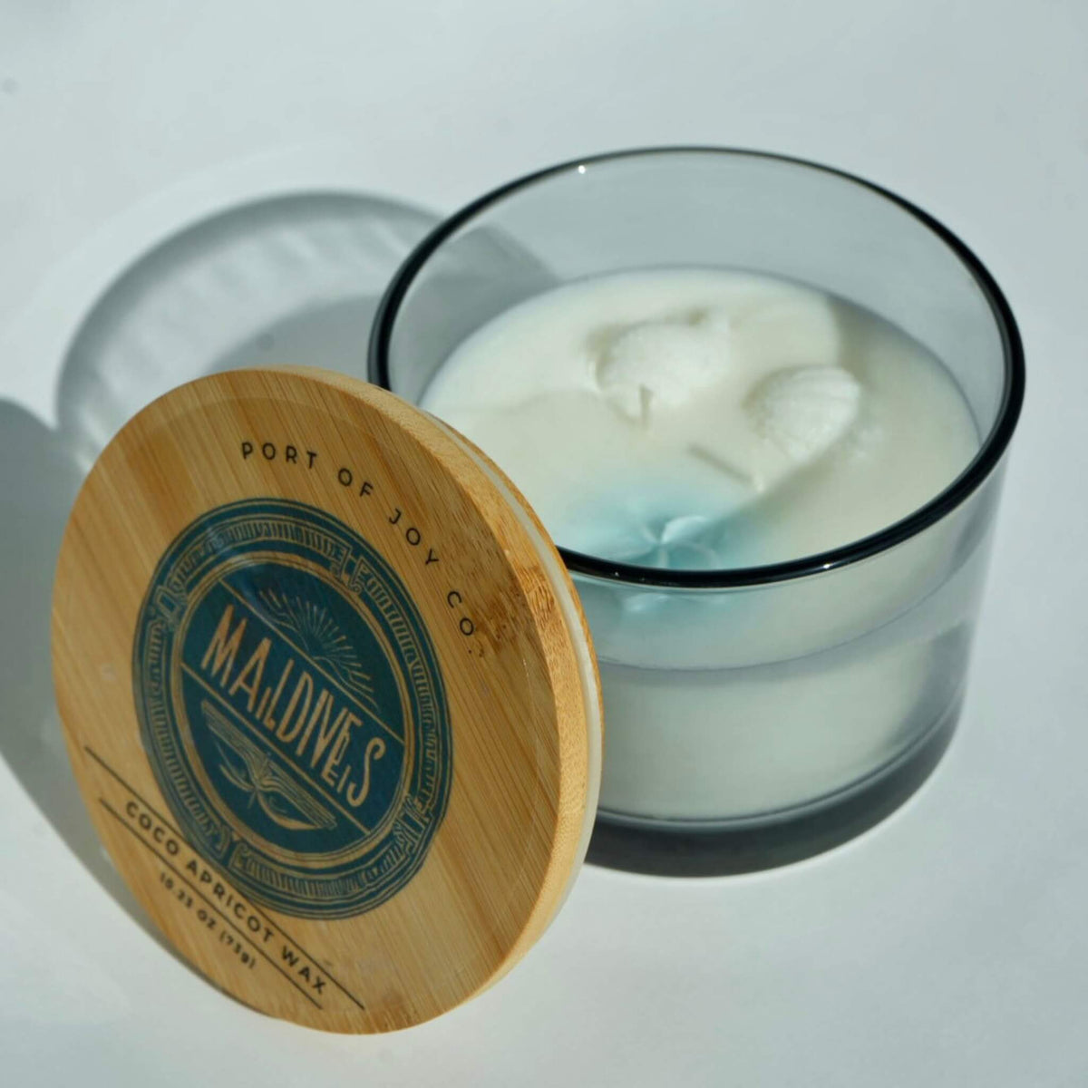 maldives bungalow candle open. Fresh aquatic scented candle featuring sea salt, eucalyptus, sandalwood, and soft musk.