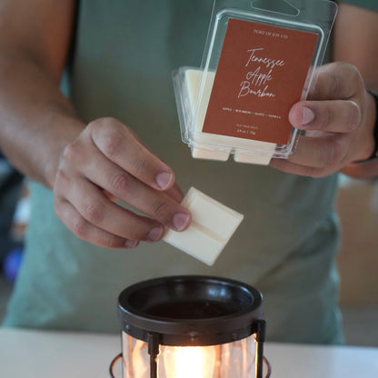 customer using a tennessee apple bourbon wax melt in a wax warmer