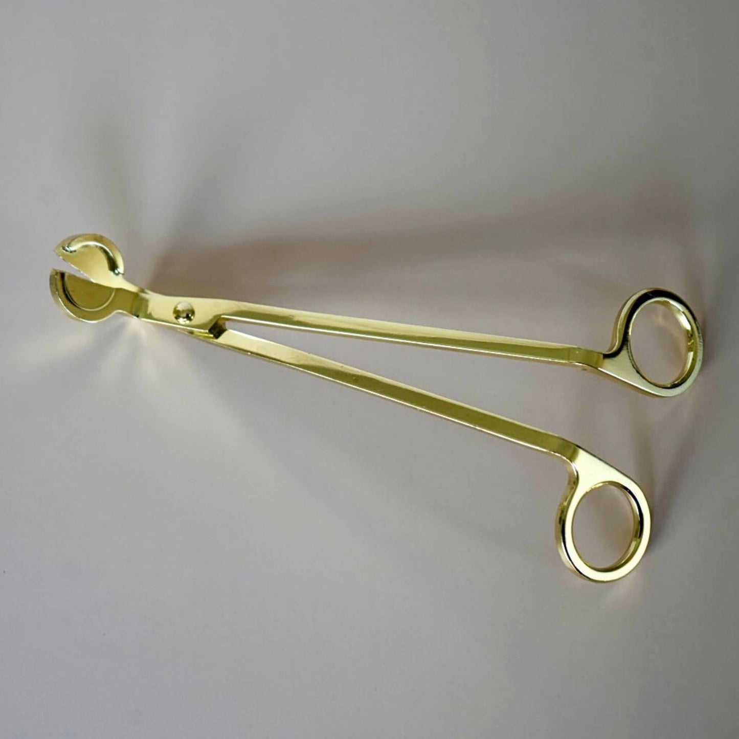 gold candle wick trimmer tool close up angled blade