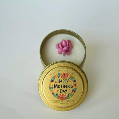 Candle in a 'Happy Mother's Day' tin with a pink rose on a white background