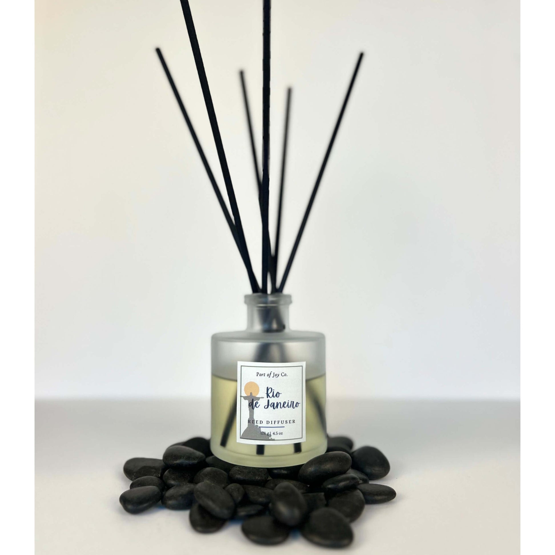 Reed diffuser with black sticks on a white background