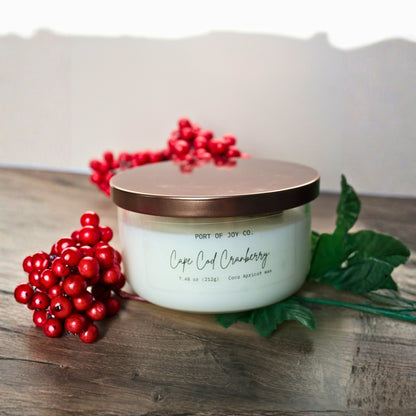 Hand poured Cape Cod Cranberry candle in minimalist clear glass jar with bronze lid, a luxurious eco-friendly holiday candle and thoughtful Christmas gift for women.