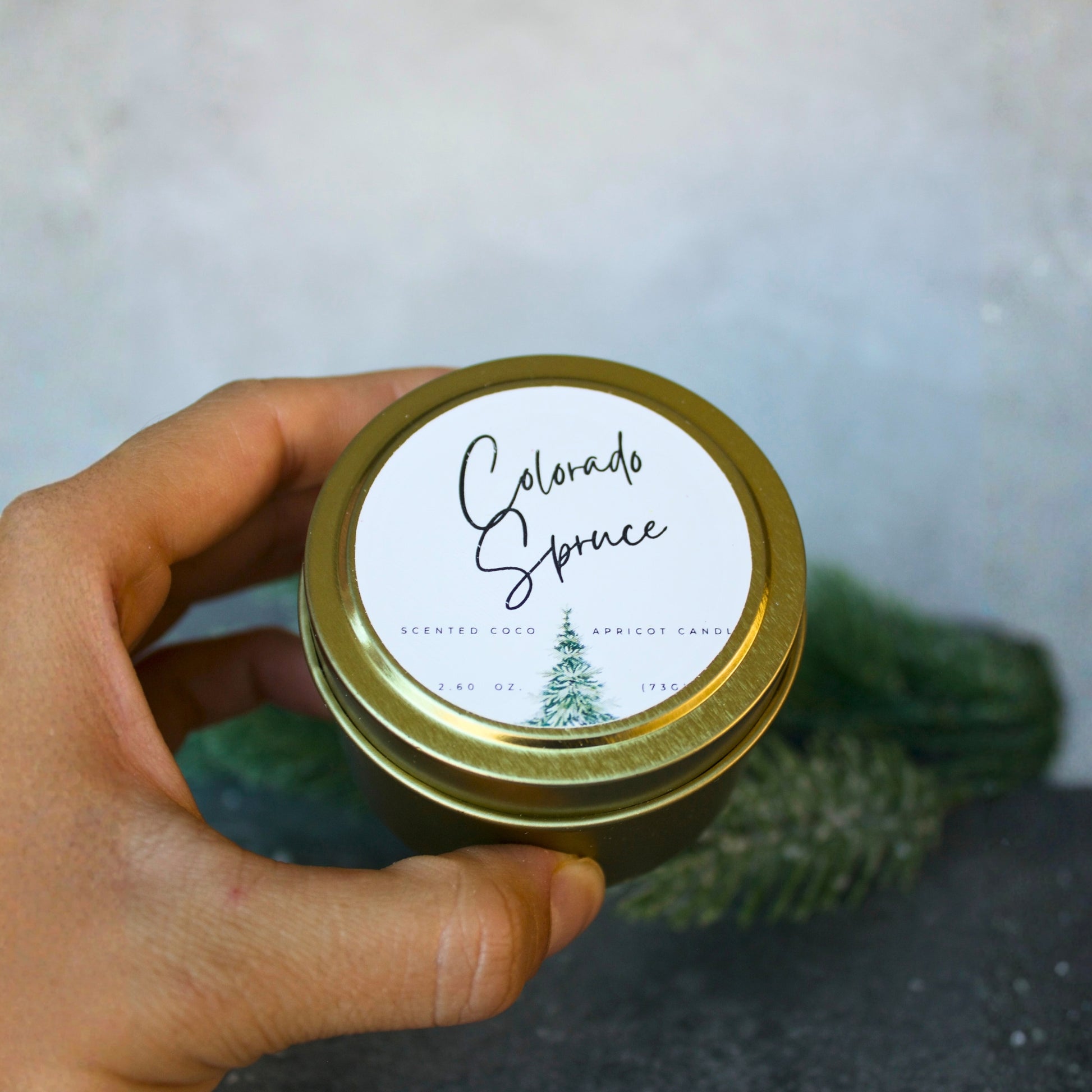 Port of Joy Colorado Spruce tin candle, a festive holiday candle with notes of eucalyptus, spruce, cedar, and amber, perfect eco-friendly Christmas stuffer or gift.