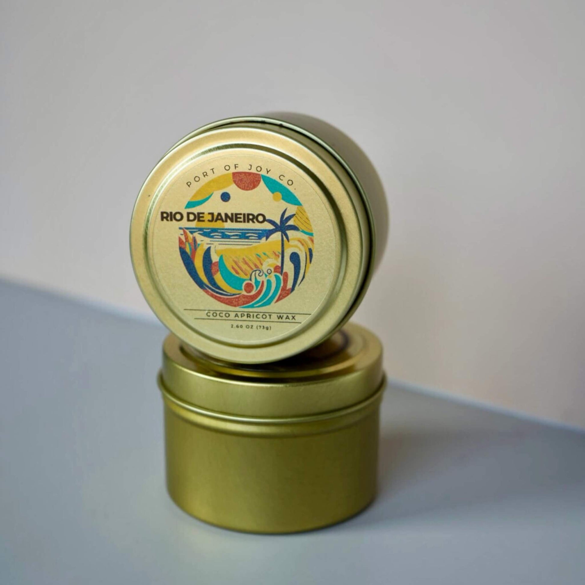 Gold candle tin with colorful Rio de Janeiro label on a light gray background