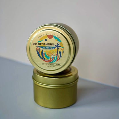 Gold candle tin with colorful Rio de Janeiro label on a light gray background