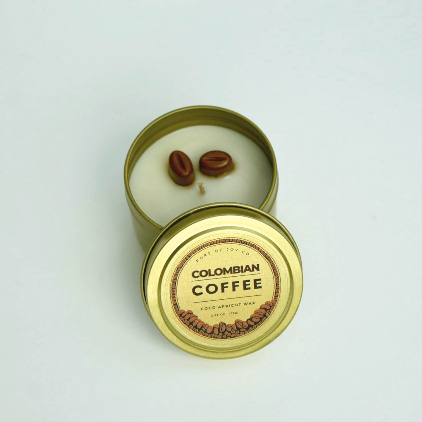 colombian coffee travel gold tin candle with lid.