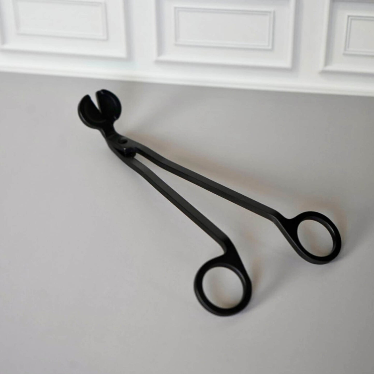 lifestyle picture of black metal black candle trimmer