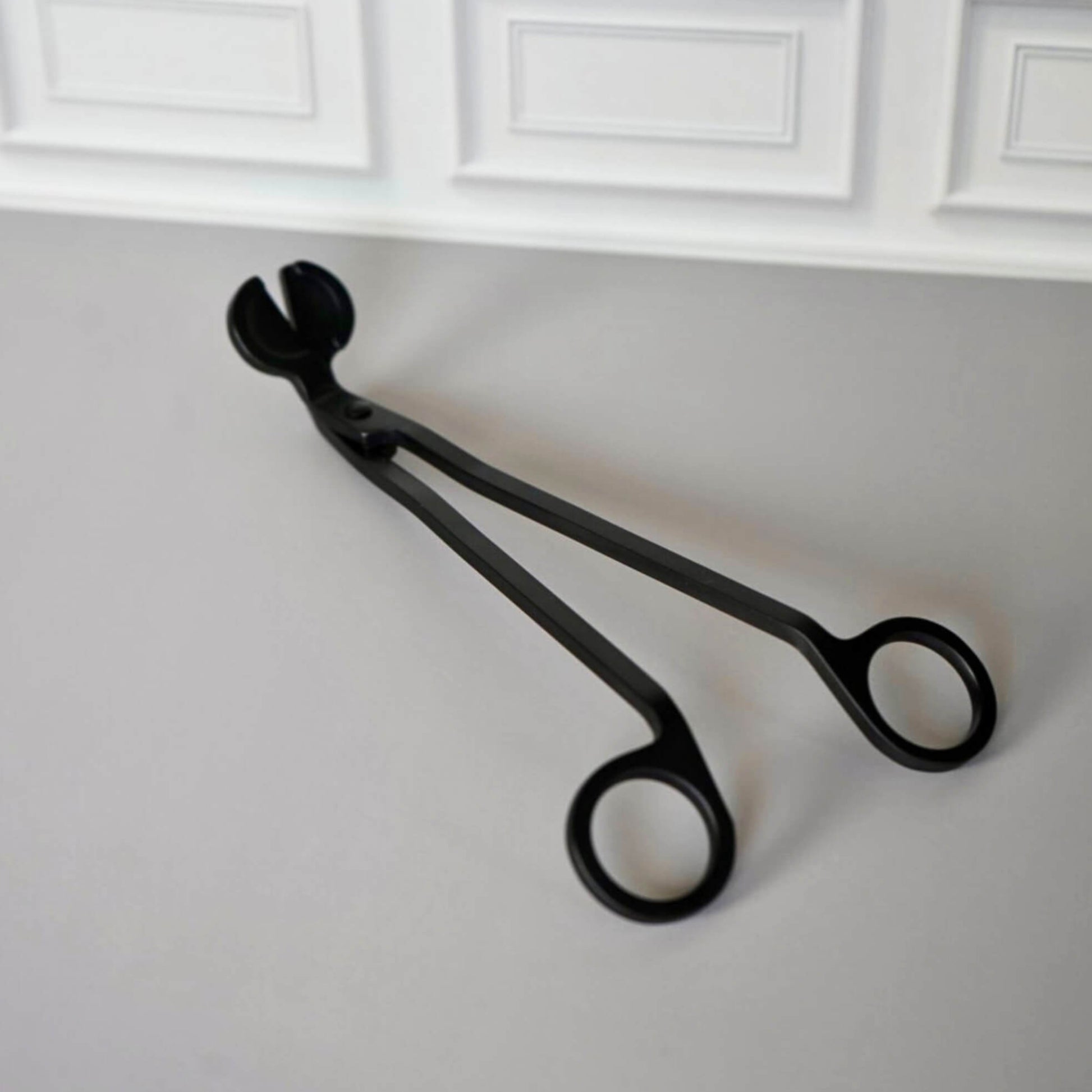 lifestyle picture of black metal black candle trimmer