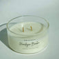 White candle in a glass container with 'Port of Joy Co.' branding on a light background