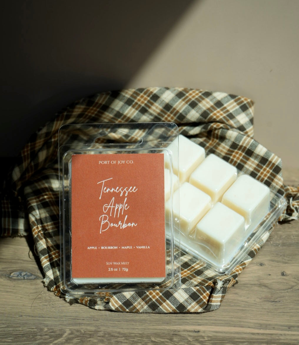 A clear plastic clamshell package of Port of Joy Co. Tennessee Apple Bourbon wax melts 