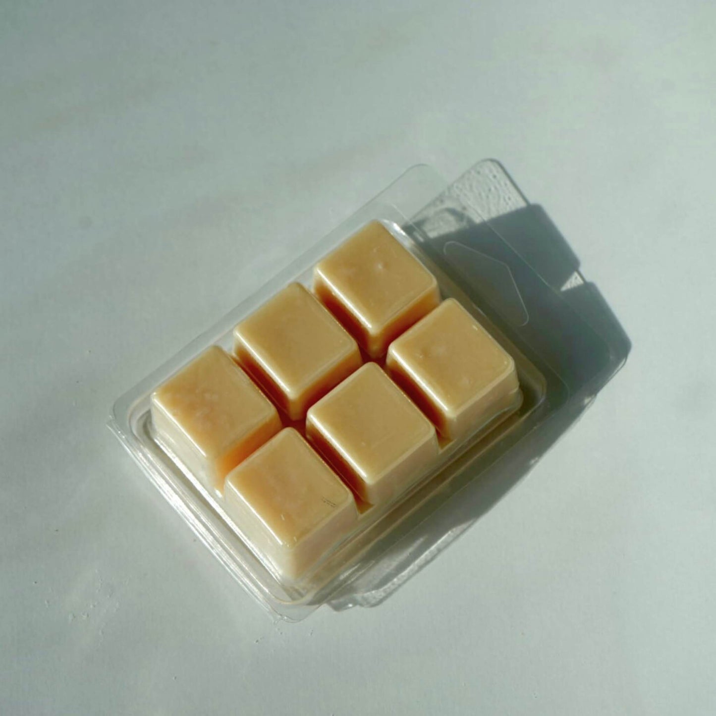 Pack of square wax melts in clear plastic packaging labeled as cedar wood forest.